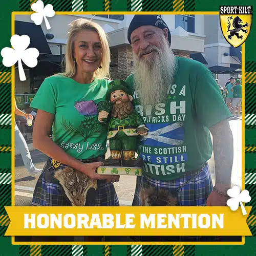 Two people wearing kilts and holding a gnome