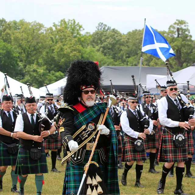 People wearing kilts and playing the bagpipes